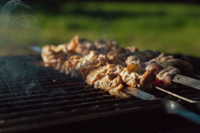 Shish kebab made from chicken and cooked on barbecue grill over charcoal. outdoor food concept.