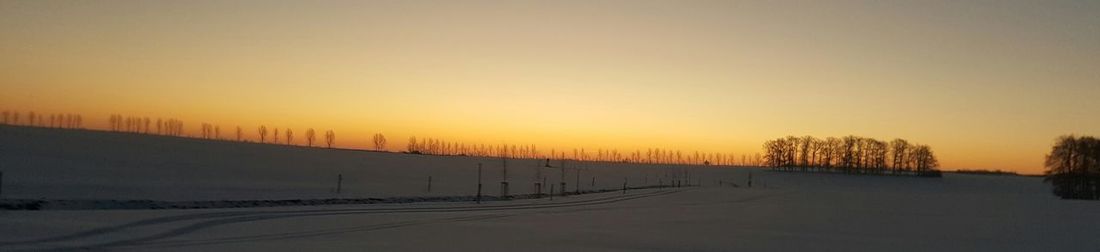 Scenic view of landscape against sky during winter