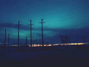 Windmills on landscape against sky