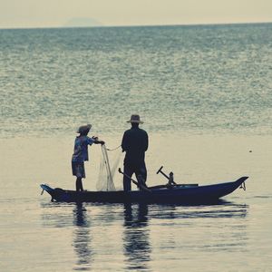 Woman fishing in sea