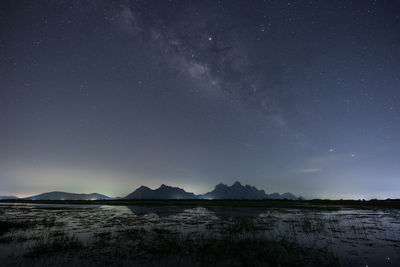 Scenic view of lake against sky at night