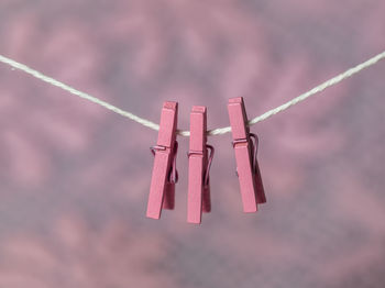 Low angle view of clothespins hanging on rope