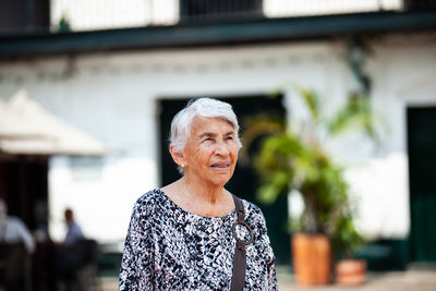 Senior adult woman at the central square in the city of guaduas. senior travel concept.