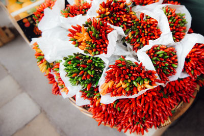 High angle view of red flowers on table at market stall