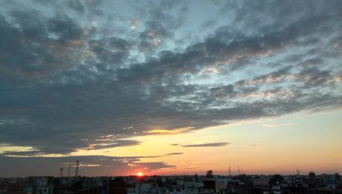 Scenic view of buildings against sky during sunset