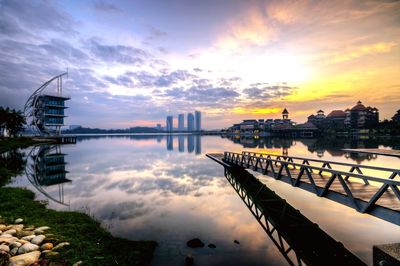 View of pier on river against sky during sunset