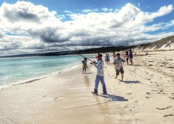 Scenic view of beach against cloudy sky