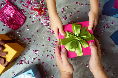 Directly above shot of hands holding gifts