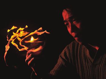 Close-up of hands over black background