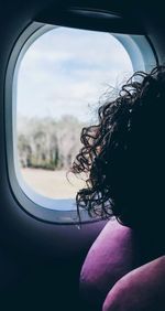 Close-up of person seen through car window