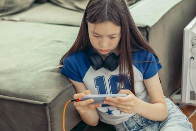 Portrait of young woman using mobile phone
