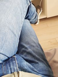 Low section of man sitting at home