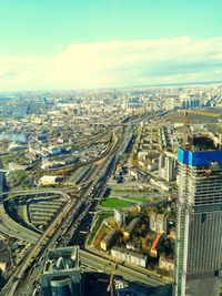 High angle view of city by buildings against sky