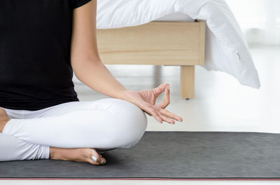 Midsection of woman sitting at home