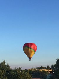 Low angle view of hot air balloon against blue sky