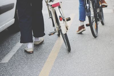 Low section of man with bicycle on street