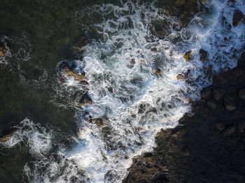 High angle view of water flowing through rocks