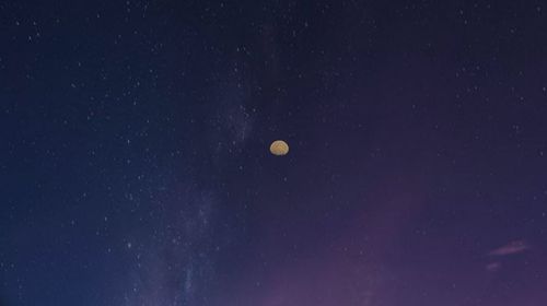 Low angle view of moon against sky at night