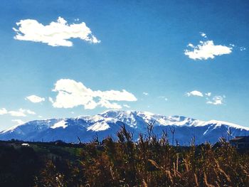 Scenic view of mountains against blue sky