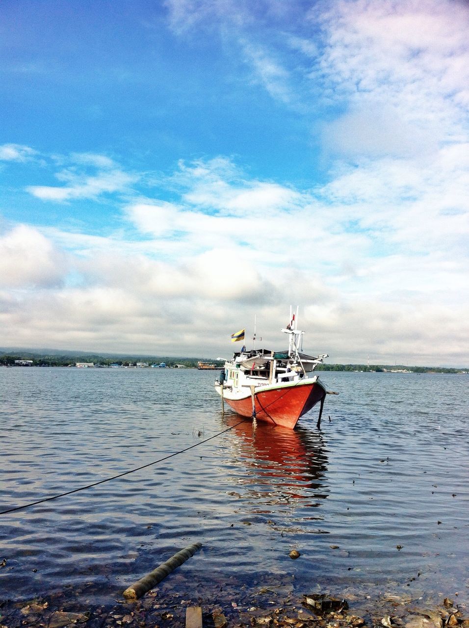 water, nautical vessel, sea, transportation, boat, sky, mode of transport, horizon over water, cloud - sky, moored, tranquility, tranquil scene, nature, scenics, beauty in nature, cloud, rippled, waterfront, cloudy, day