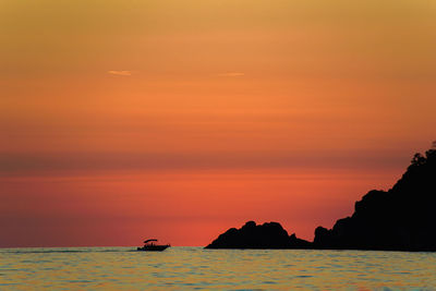 Scenic view of sea against orange sky