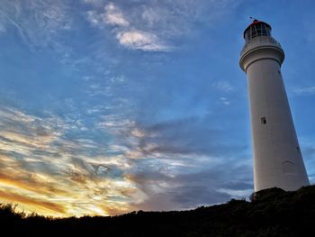 Low angle view of lighthouse against sky during sunset