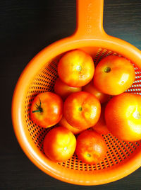 High angle view of oranges in basket on table