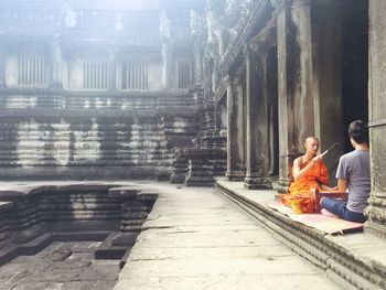 People sitting outside building