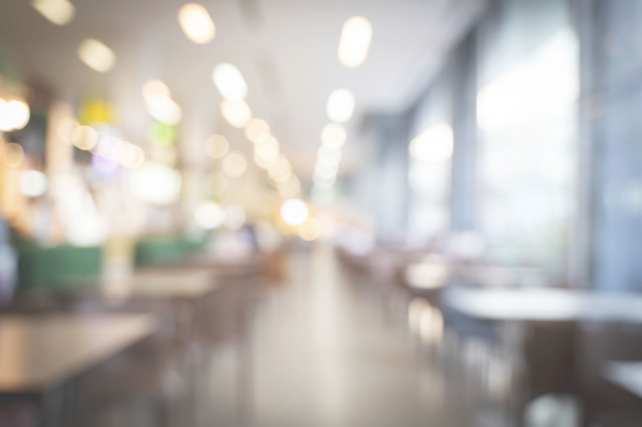 DEFOCUSED IMAGE OF ILLUMINATED LIGHTS ON TABLE IN BUILDING