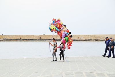 Group of people against clear sky