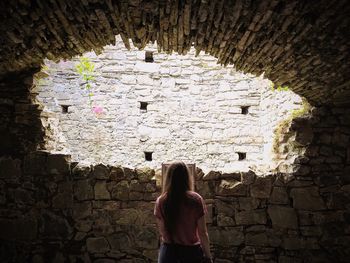 Low angle view of a woman standing in front of a building