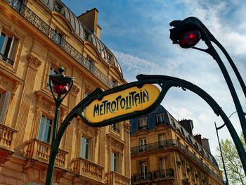 Low angle view of road sign against building