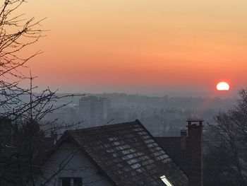 Buildings in city during sunset