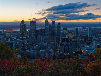 Aerial view of buildings in city during sunset