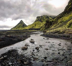 Scenic view of mountains against cloudy sky