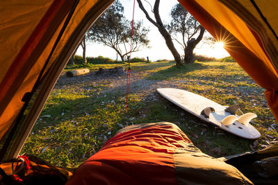 Low section of person relaxing on field