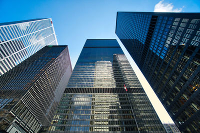 Low angle view of modern buildings against sky in city