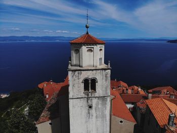 Tower amidst buildings against sky in city