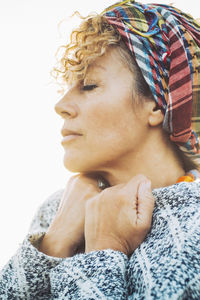 Portrait of young woman against white background