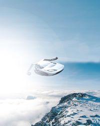 Aerial view of snow and sea against sky