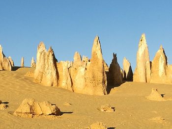 Panoramic view of arid landscape against clear sky