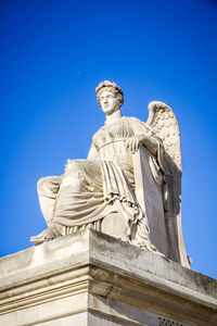 Low angle view of statue against clear blue sky