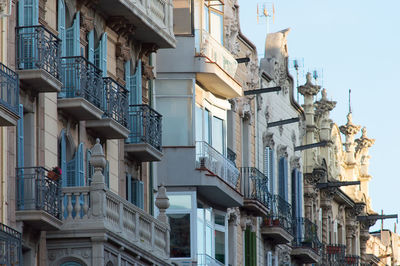 Low angle view of buildings in town against sky