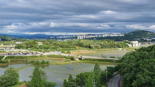 High angle view of trees and buildings against sky