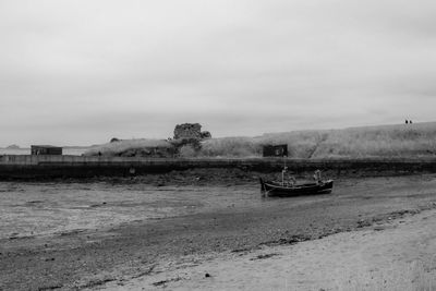 Boats moored on sea against sky