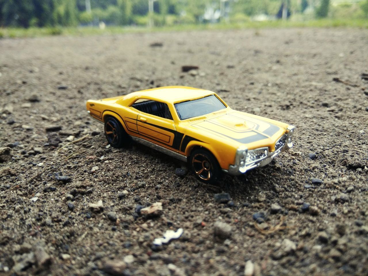 CLOSE-UP OF YELLOW TOY CAR