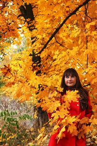 Portrait of smiling woman with autumn leaves