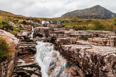 View of waterfall against rocks