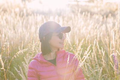 Young woman looking away on field