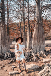 Full length of woman standing in forest